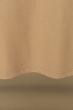Polo shirt fabric close-up with curved hem seam and visible stitching