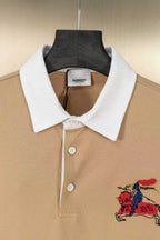 Tan polo shirt with white collar, button placket, and colorful horse emblem