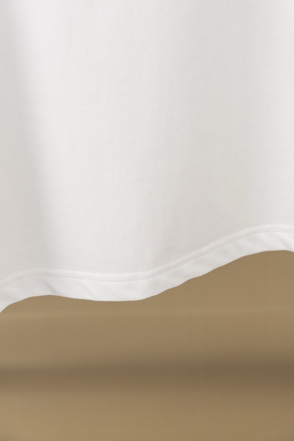 White polo shirt fabric hem and side seam close-up