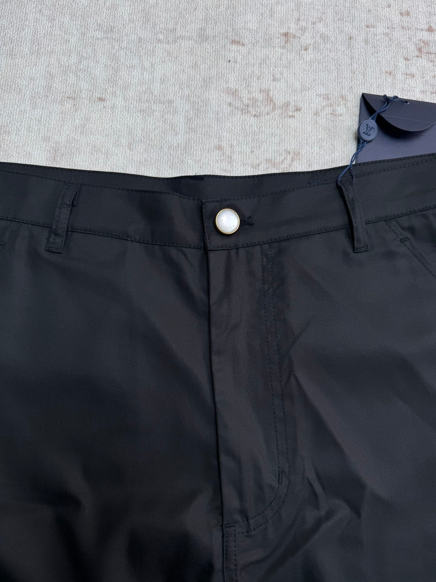 Black pants waist with button closure and belt loops