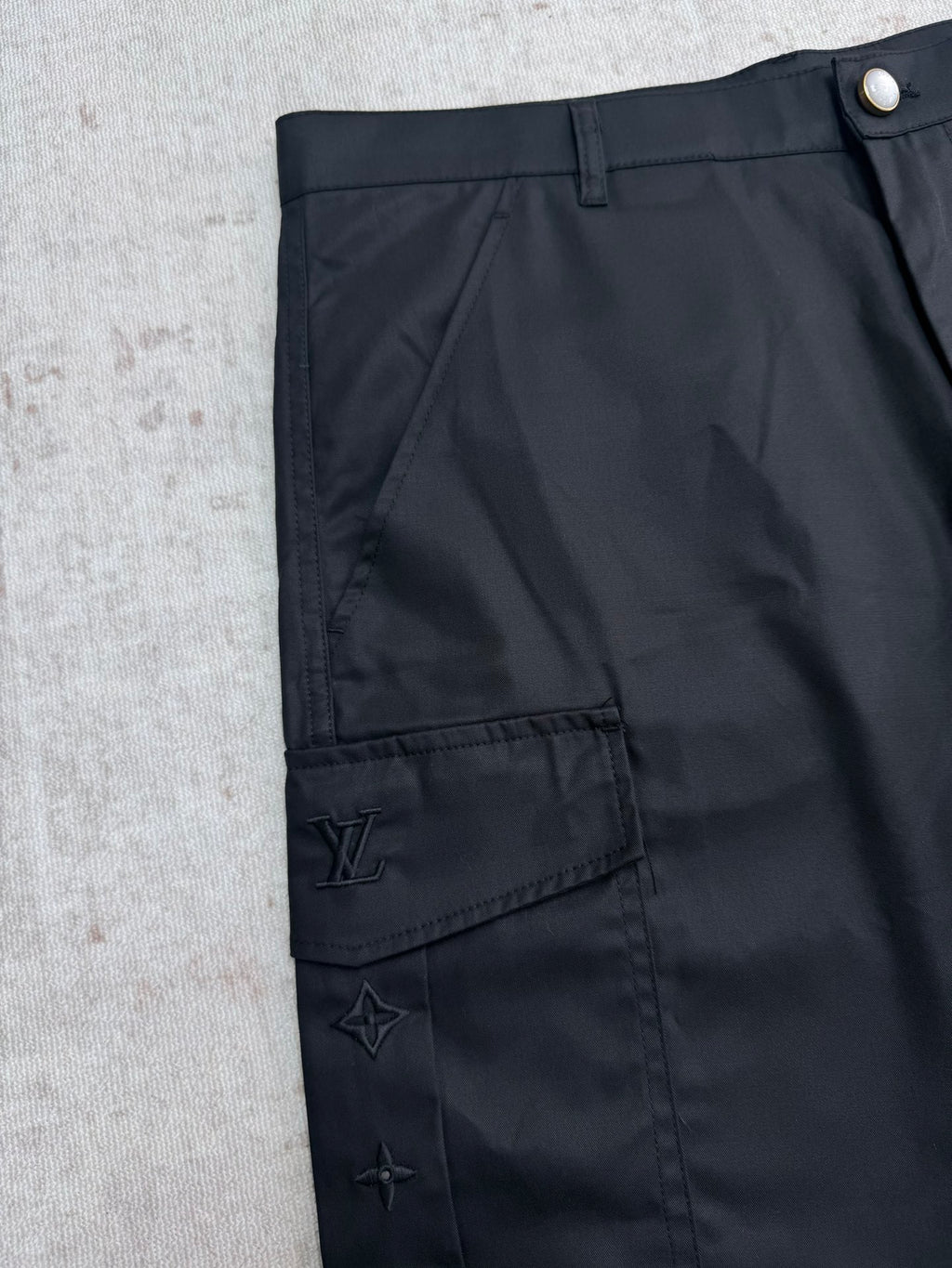 Black pants with back hem logo patch and star emblem accents