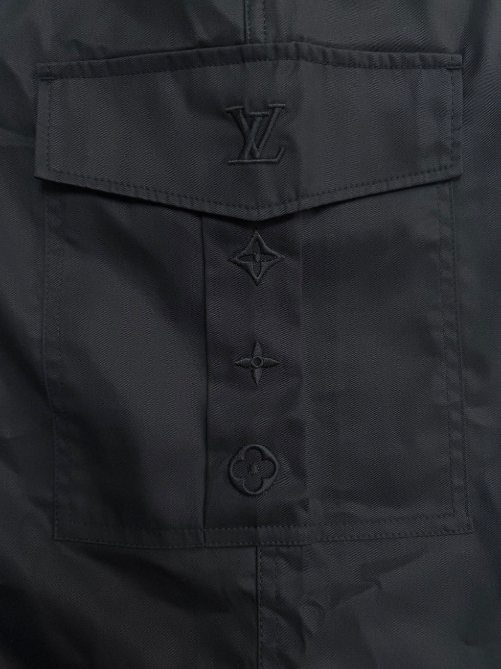 Black Louis Vuitton pants with embossed logo patch and stitched details
