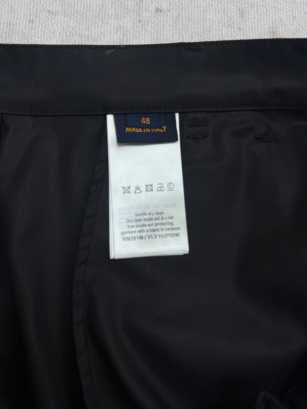 Black Louis Vuitton pants with size and care label tag