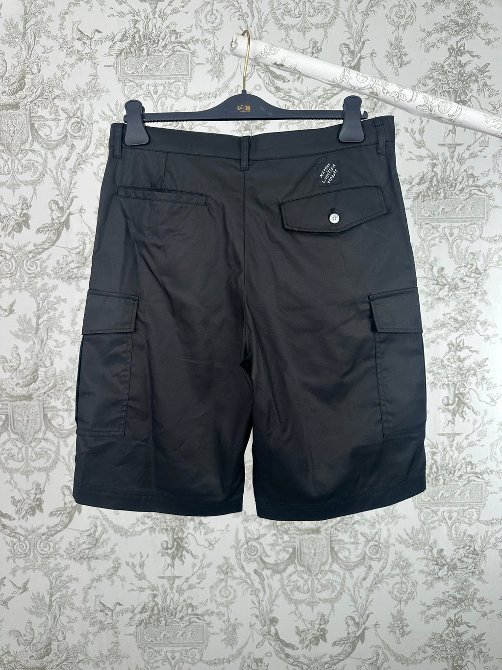 Black cargo pants with side pocket flaps and front button closure