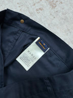 Navy Louis Vuitton shorts interior with care label and gold button.