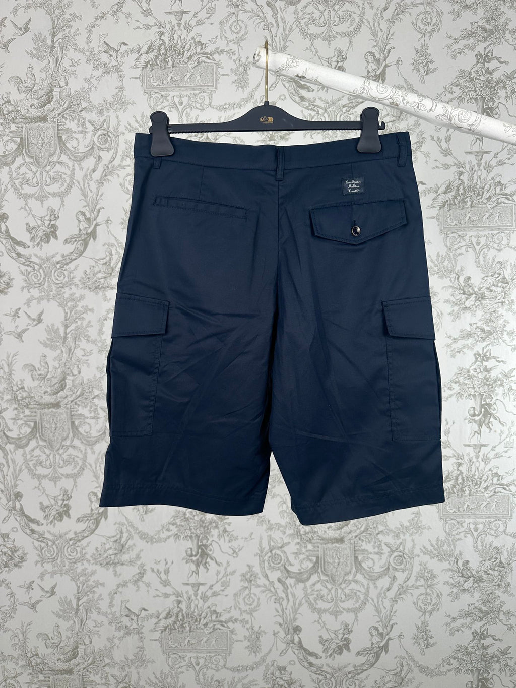 Navy Louis Vuitton cargo shorts with front pleats and side flap pockets.