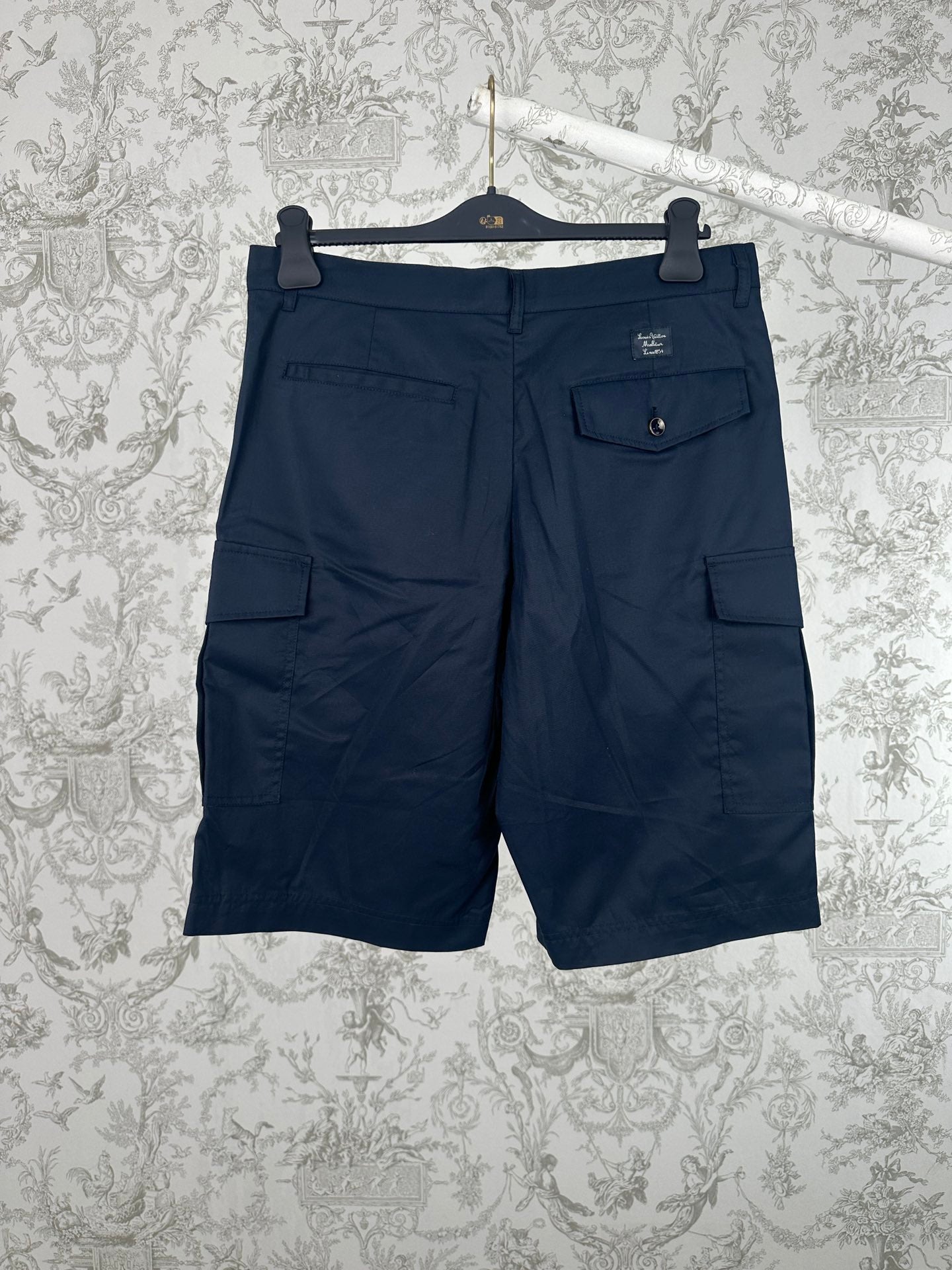 Navy Louis Vuitton cargo shorts with front pleats and side flap pockets.
