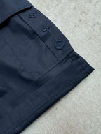 Navy Louis Vuitton shorts with pocket flaps and embroidered star and icon details.