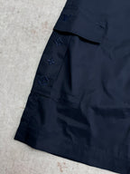 Navy Louis Vuitton shorts leg with star and monogram-style embroidered motifs.