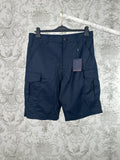 Navy Louis Vuitton cargo shorts with flap pockets and button closure.