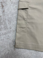 Beige cargo shorts side pocket and stitched seams close-up