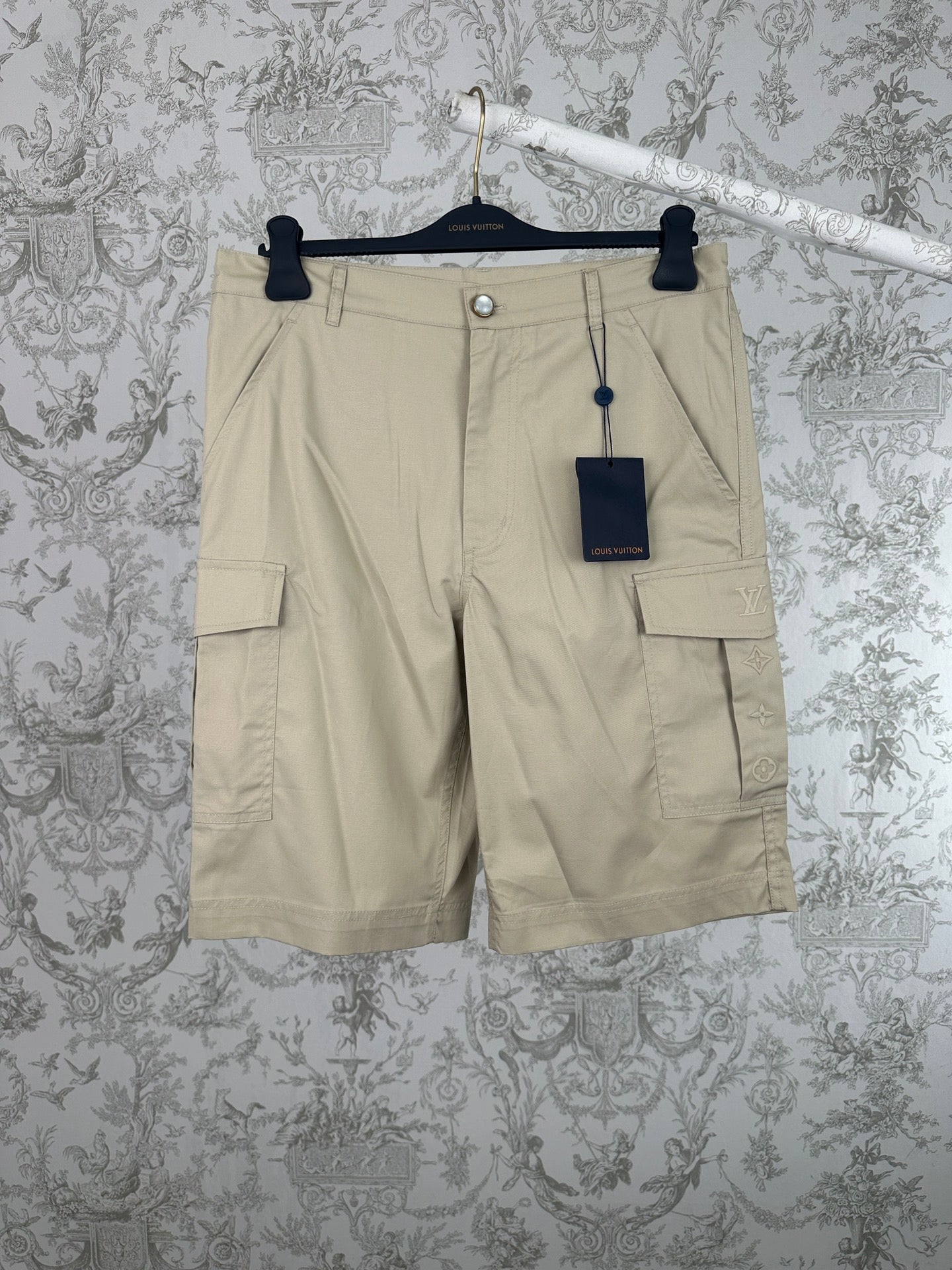 Beige cargo shorts with front button and flap pockets