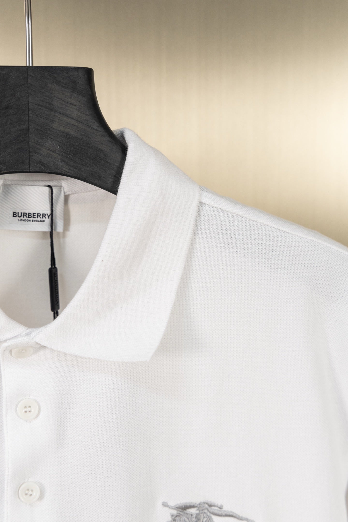 White polo shirt collar and placket with embroidered horse logo