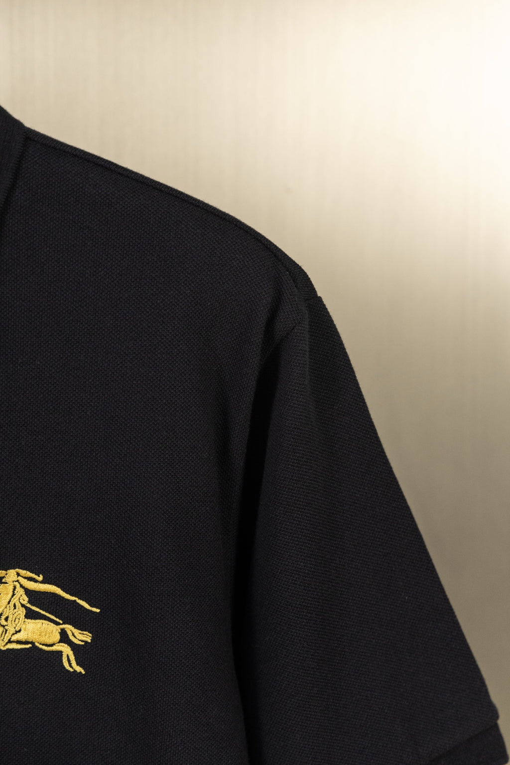 Burberry black polo shirt side with gold horse logo