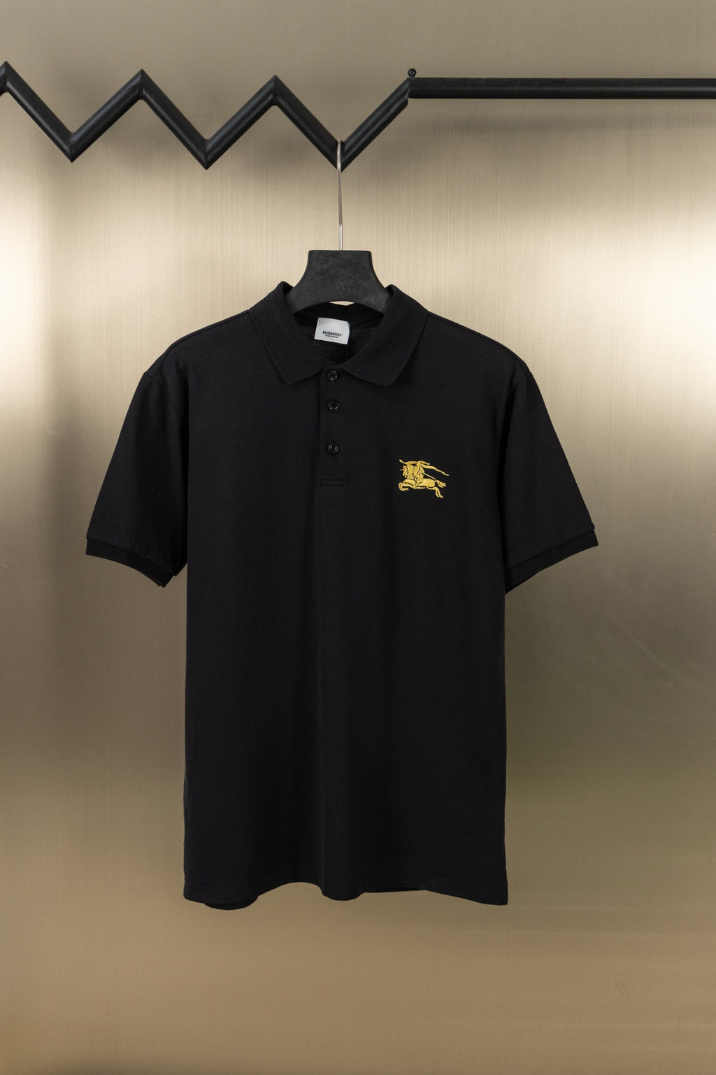 Burberry black polo shirt with gold horse logo on chest