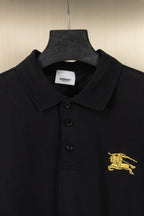 Burberry black polo shirt close-up of collar, buttons, and gold logo