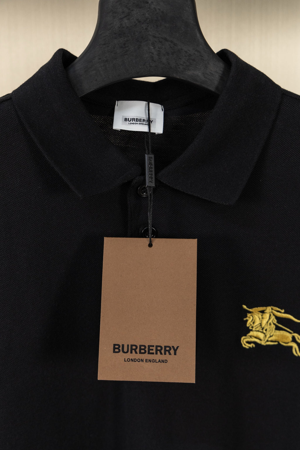 Burberry black polo shirt with hang tag and gold horse logo