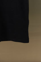 Burberry black polo shirt hem, side view