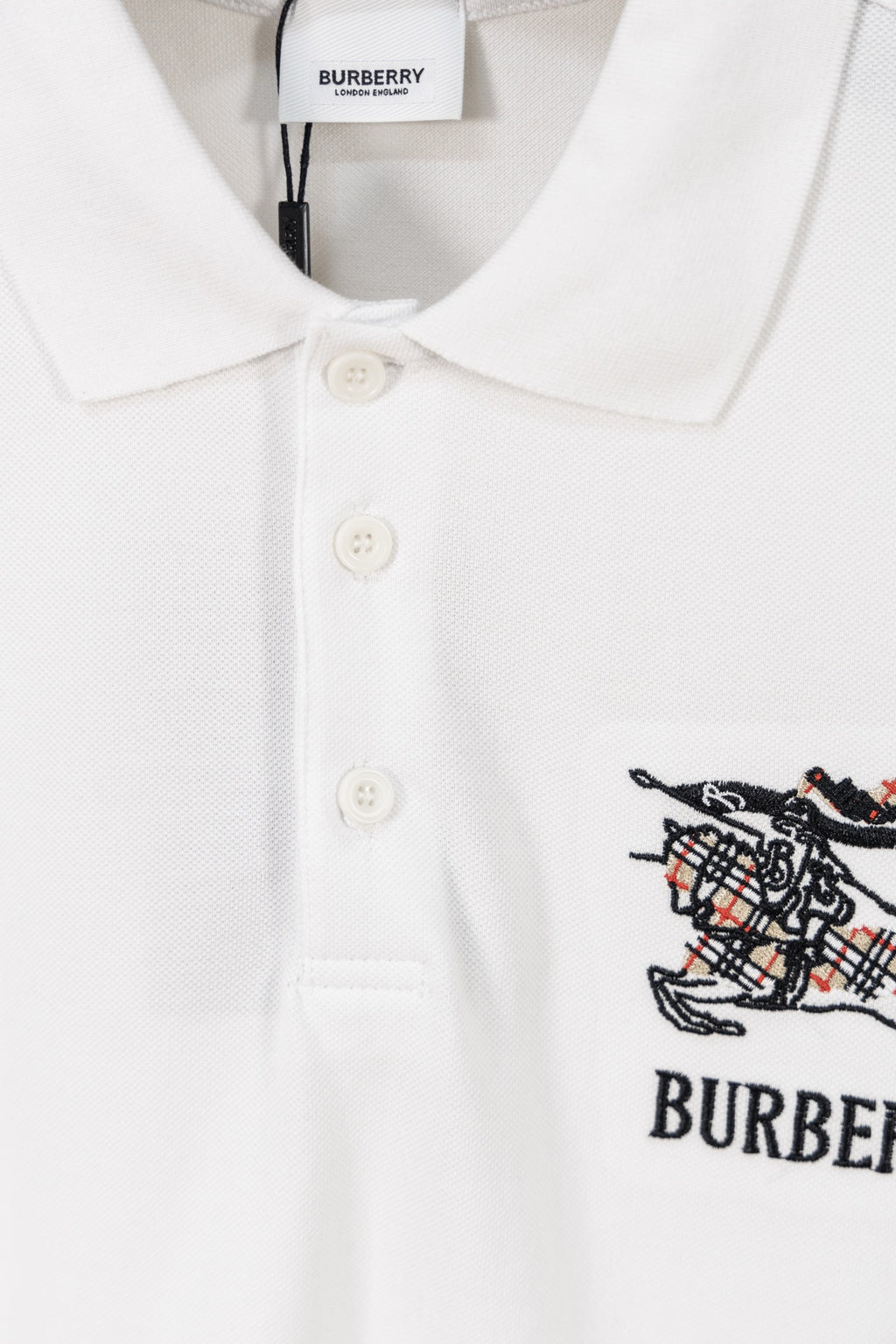 Burberry white polo shirt front with three-button placket and embroidered crest