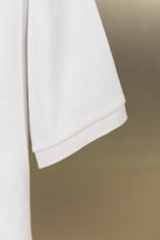 Burberry white polo shirt hem with side seam detail