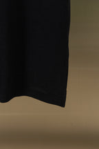 Black polo shirt side hem and lower edge detail