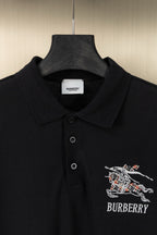 Black polo shirt with embroidered crest graphic on chest and button placket