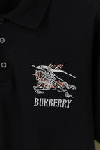 Black polo shirt with embroidered Burberry horse logo and wordmark