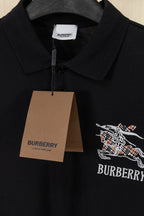 Black Burberry polo shirt with neck tag and embroidered crest on chest