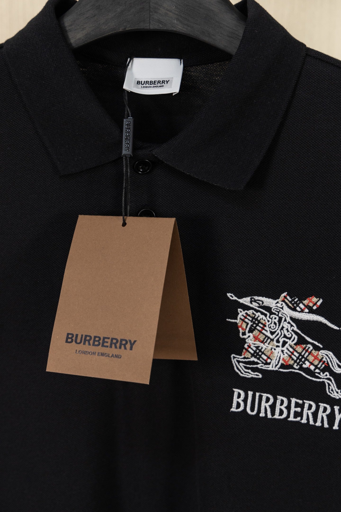 Black Burberry polo shirt with neck tag and embroidered crest on chest