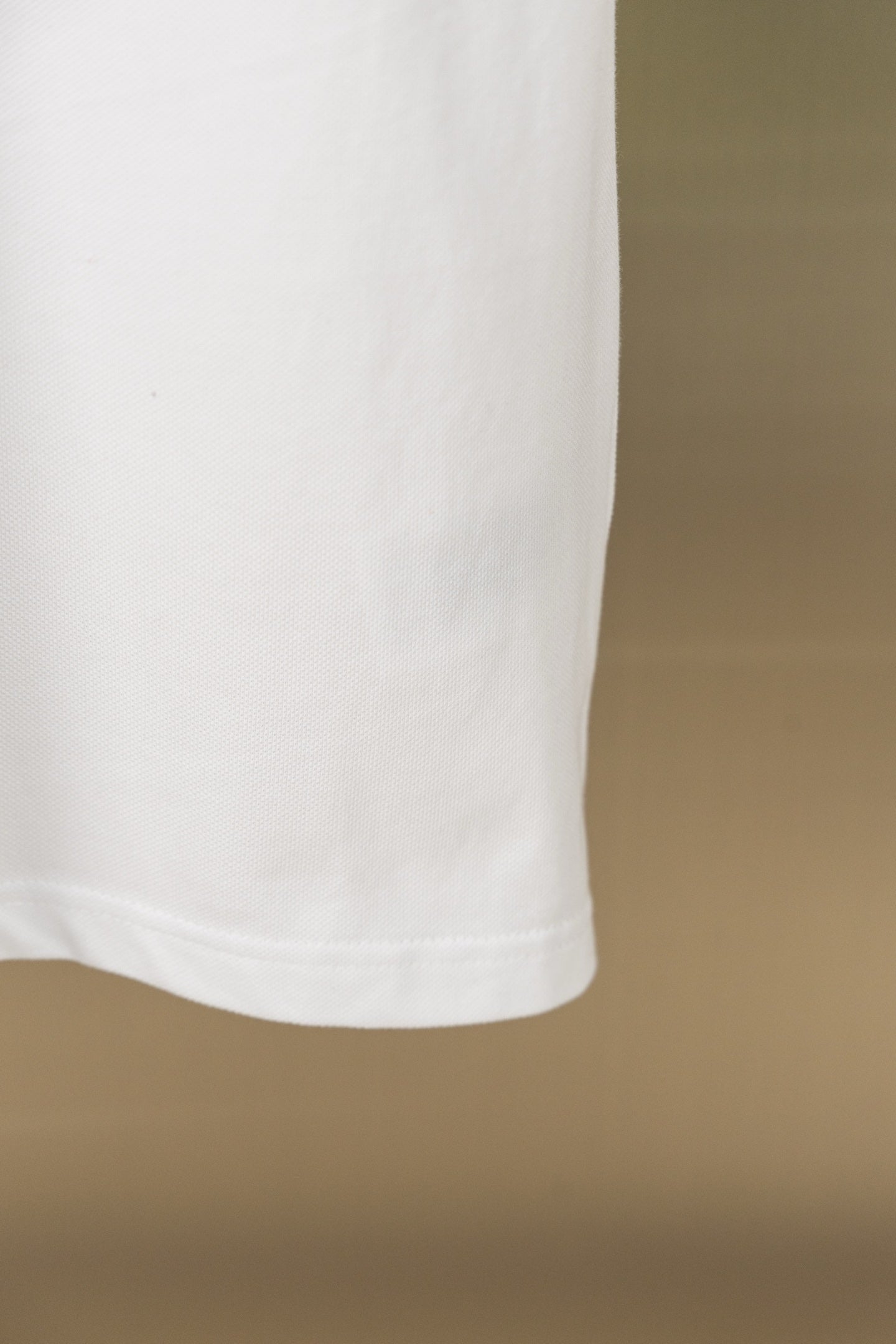 White polo shirt lower hem with side seam
