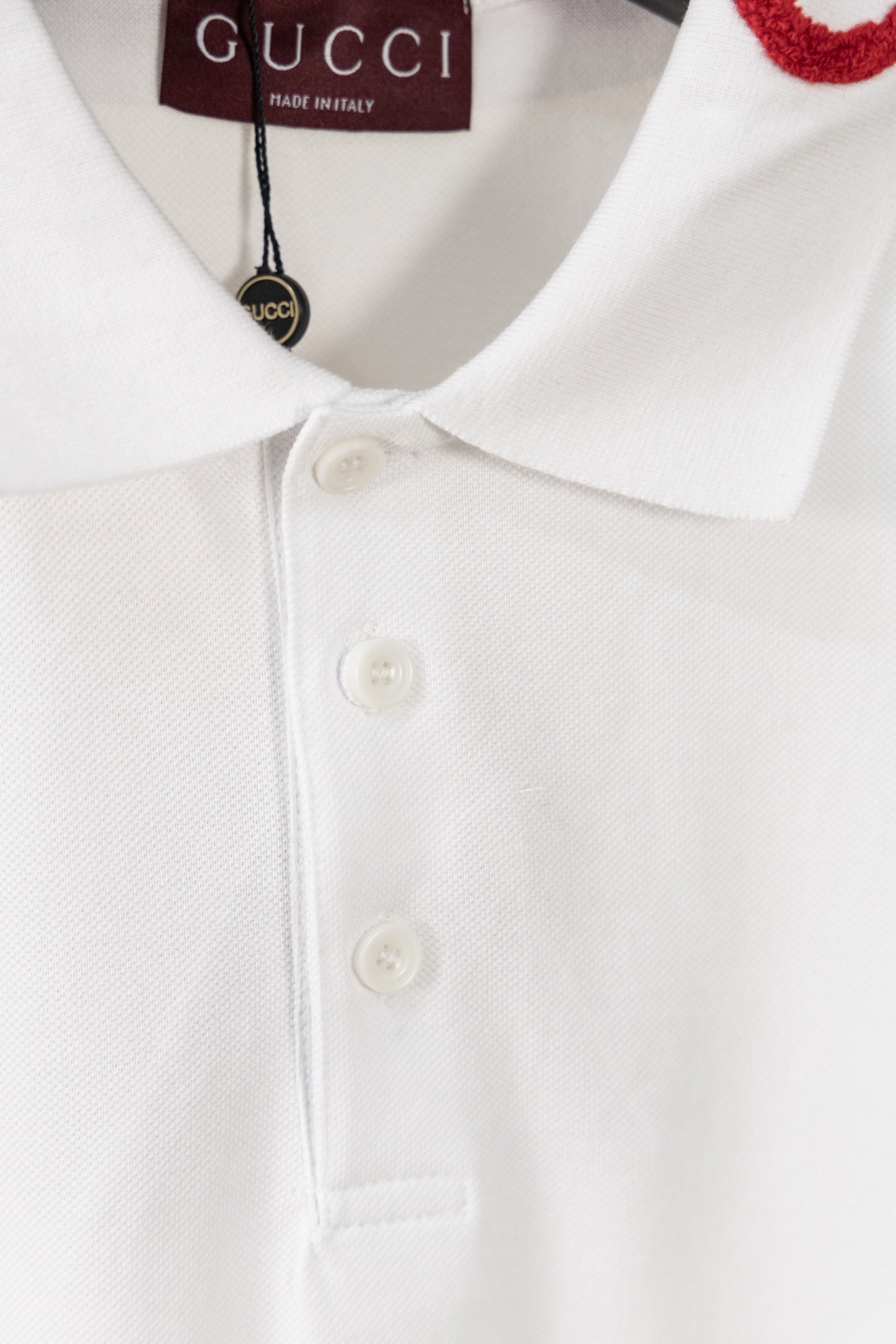 White polo shirt close-up of three-button placket and pointed collar