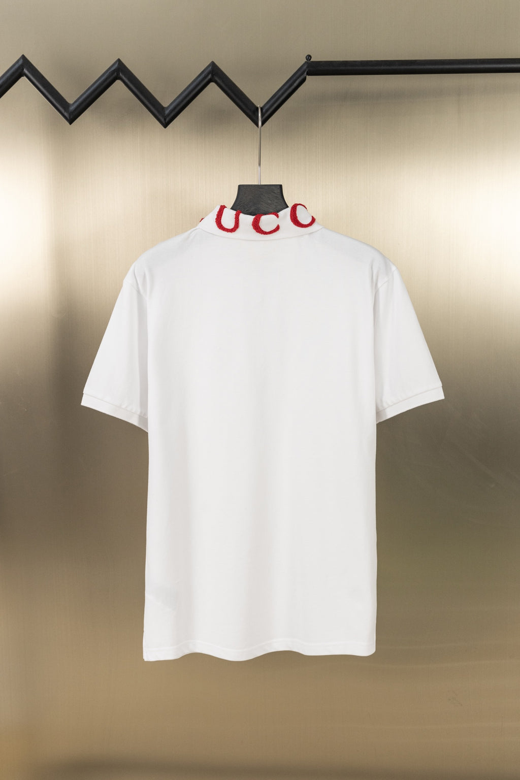 White short-sleeve polo shirt, back view, red letter embroidery at neck