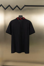 Black Gucci polo shirt, back view, short sleeves, red embroidered logo at collar