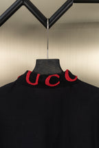 Black Gucci polo shirt collar, red embroidered logo letters at neckline
