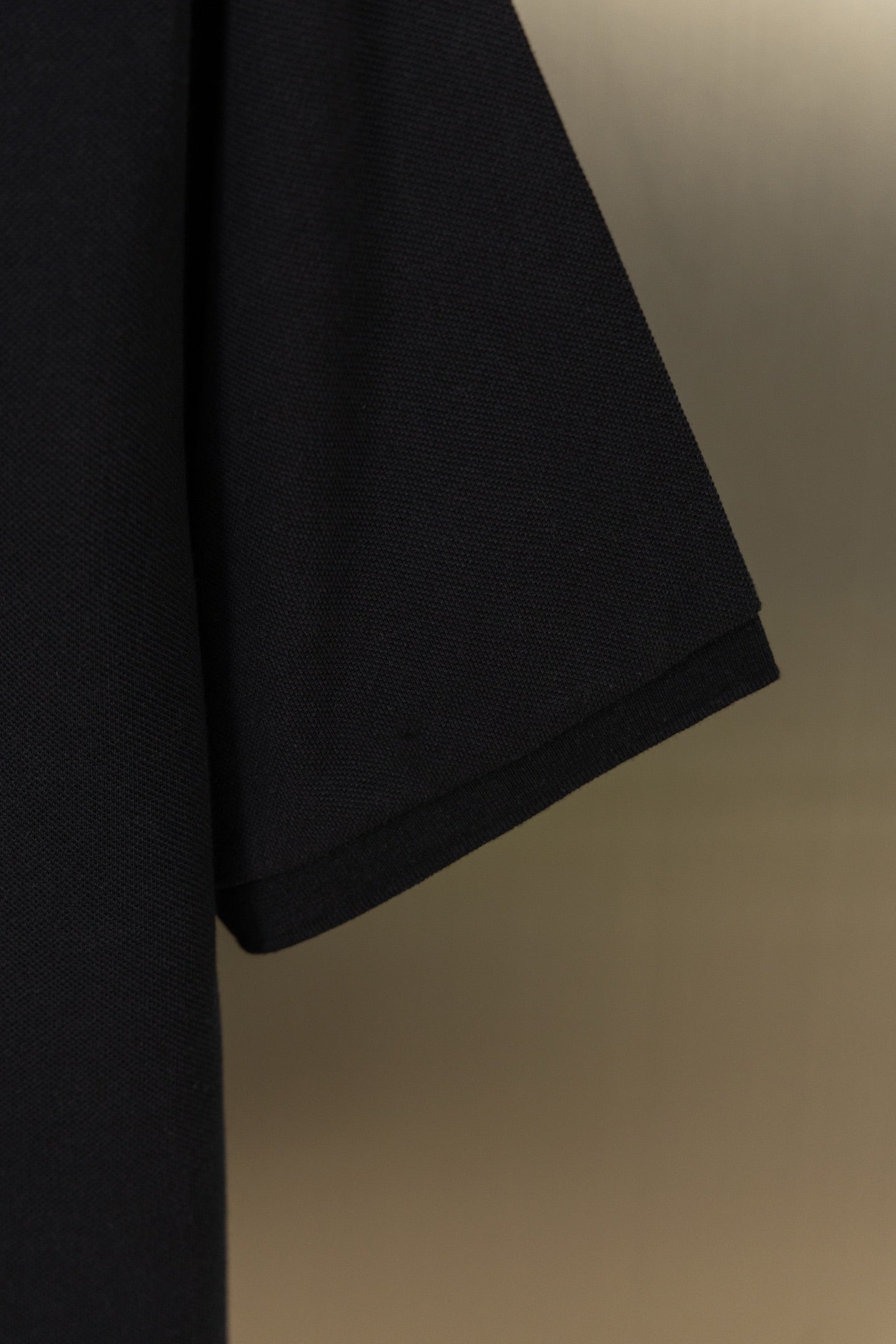 Black polo shirt short sleeve with curved hem, smooth knit fabric