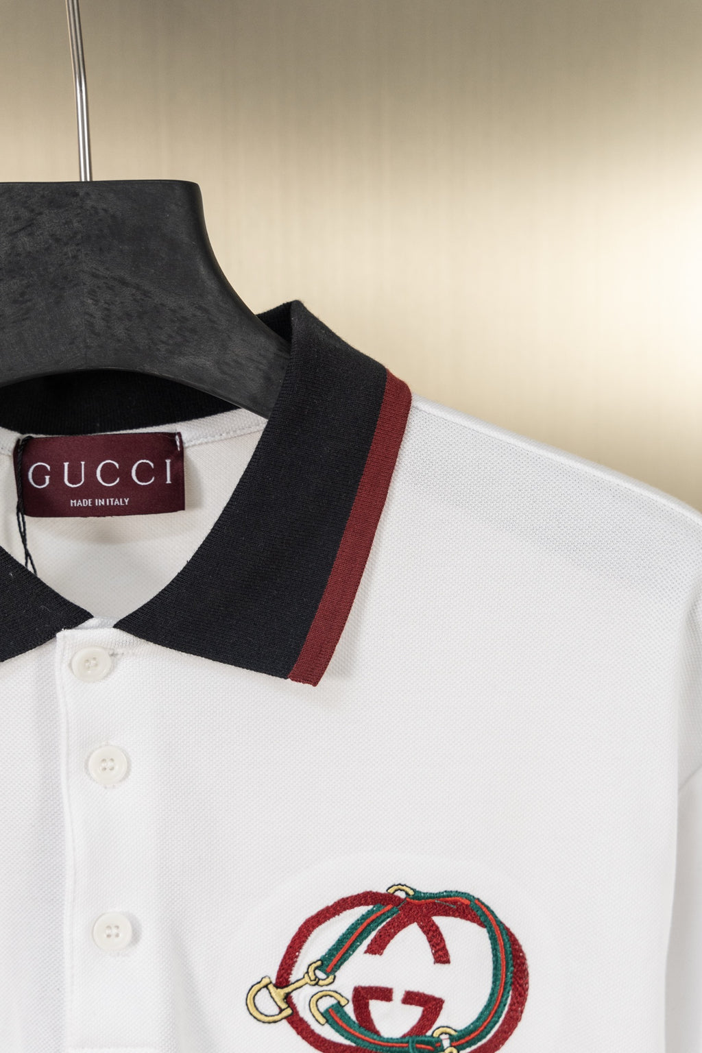 Gucci polo shirt with dark collar, red/green stripe, and embroidered logo
