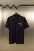Gucci short-sleeve polo shirt in dark color, red collar trim, embroidered crest at chest