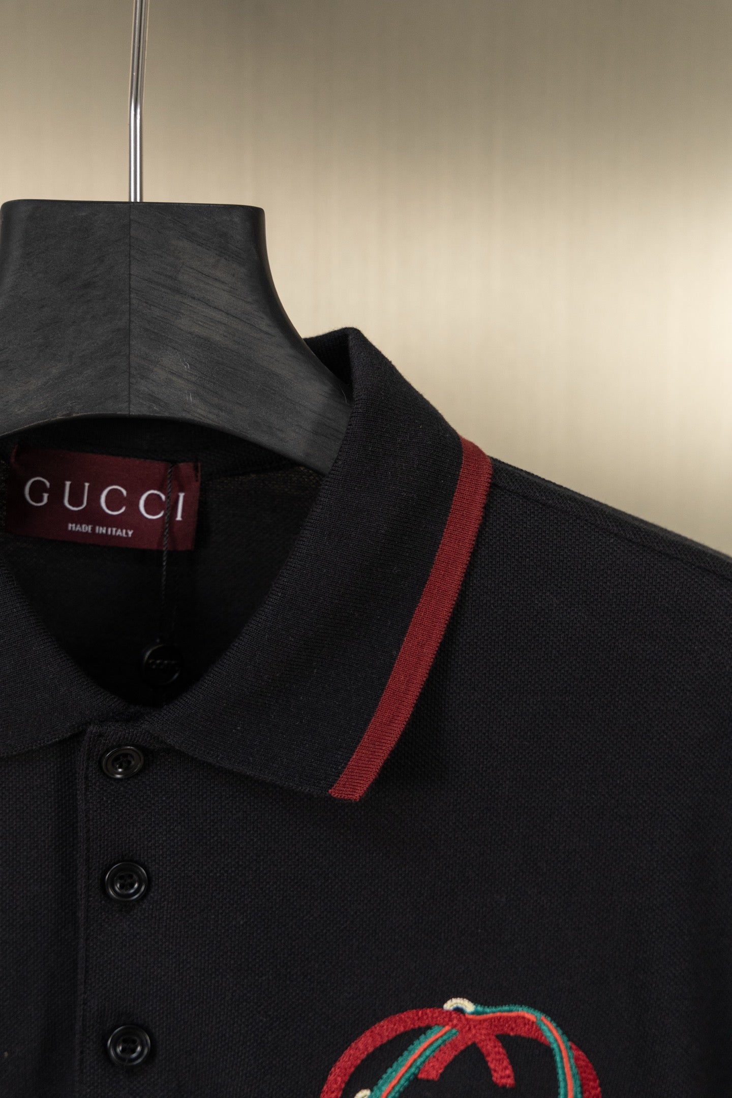 Gucci polo shirt collar detail with red stripe and crest embroidery