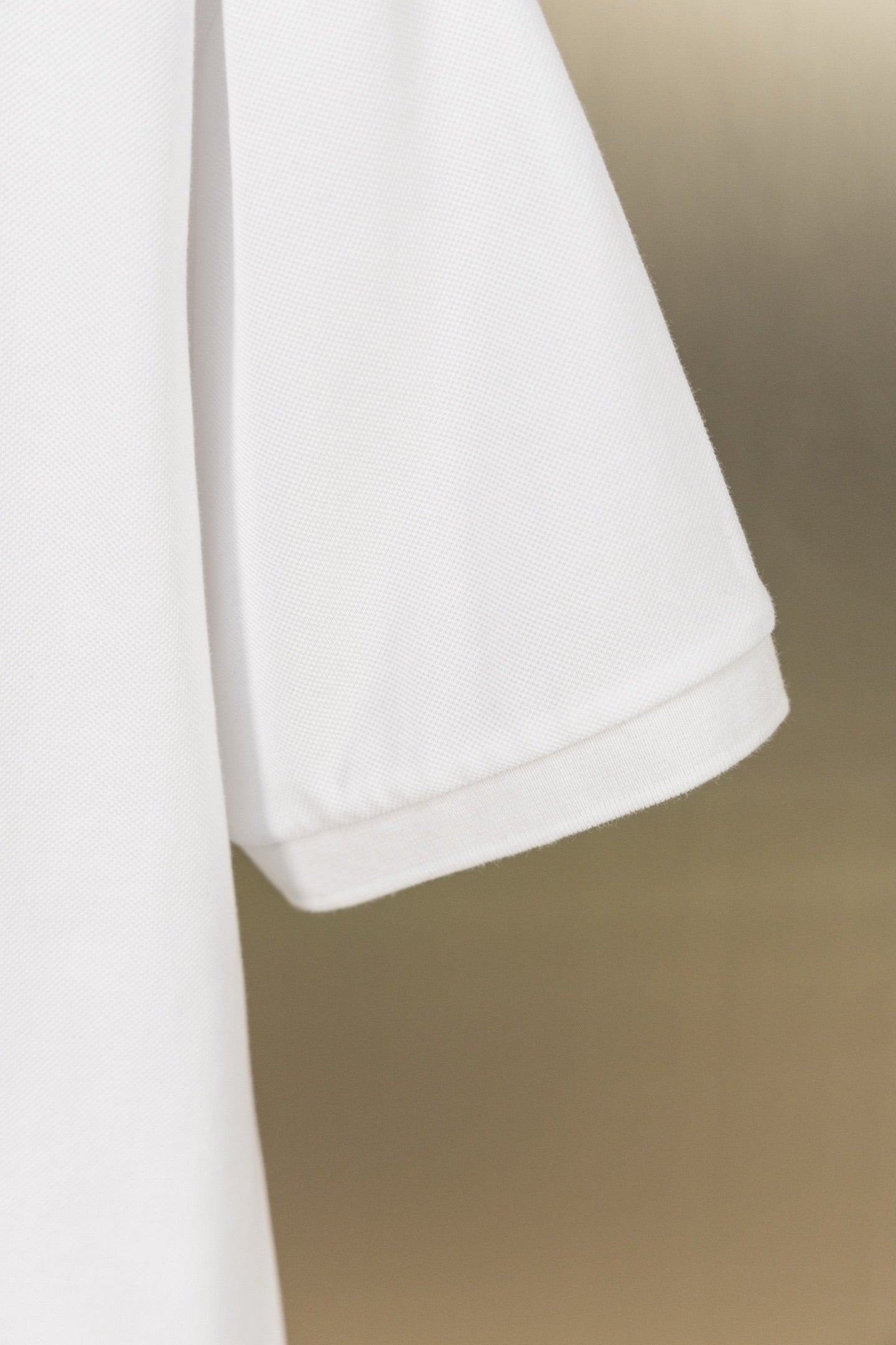 White polo shirt curved hem with side edge