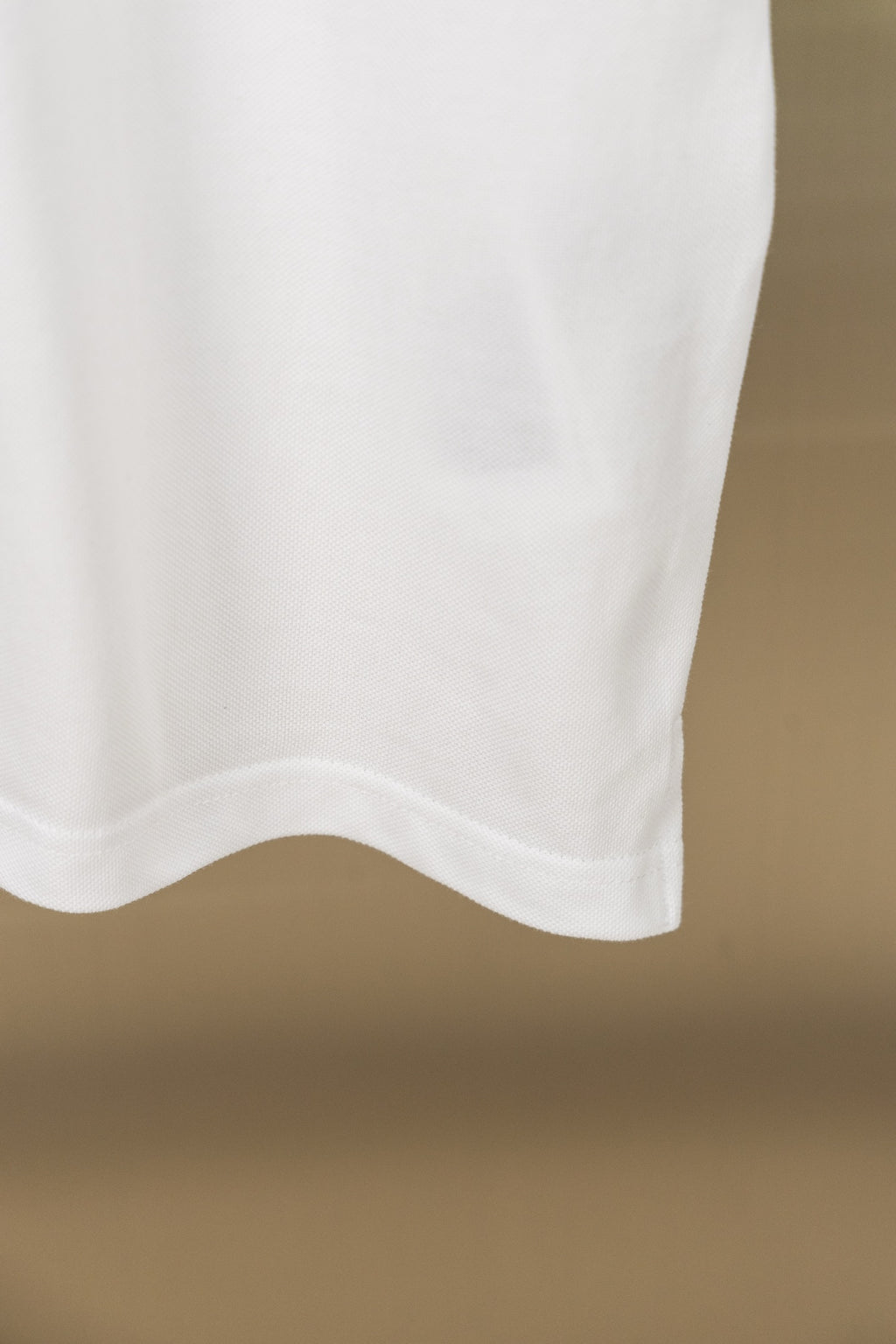 White polo shirt lower front hem