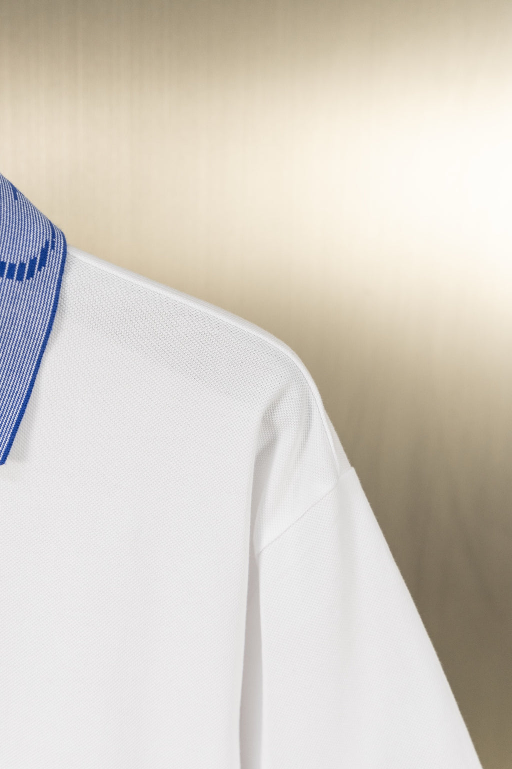 White polo shirt side with sleeve and seam detail