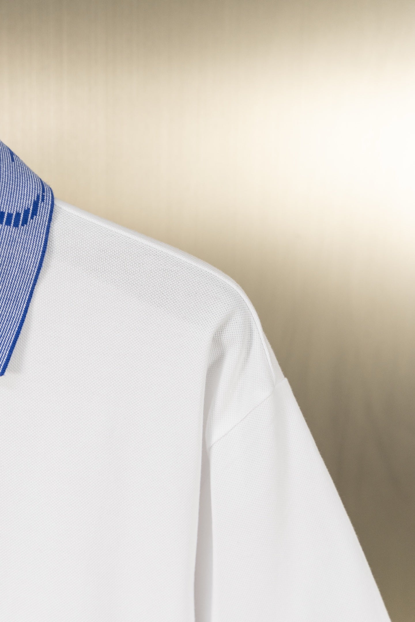 White polo shirt side with sleeve and seam detail