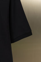 Black polo shirt lower sleeve hem detail