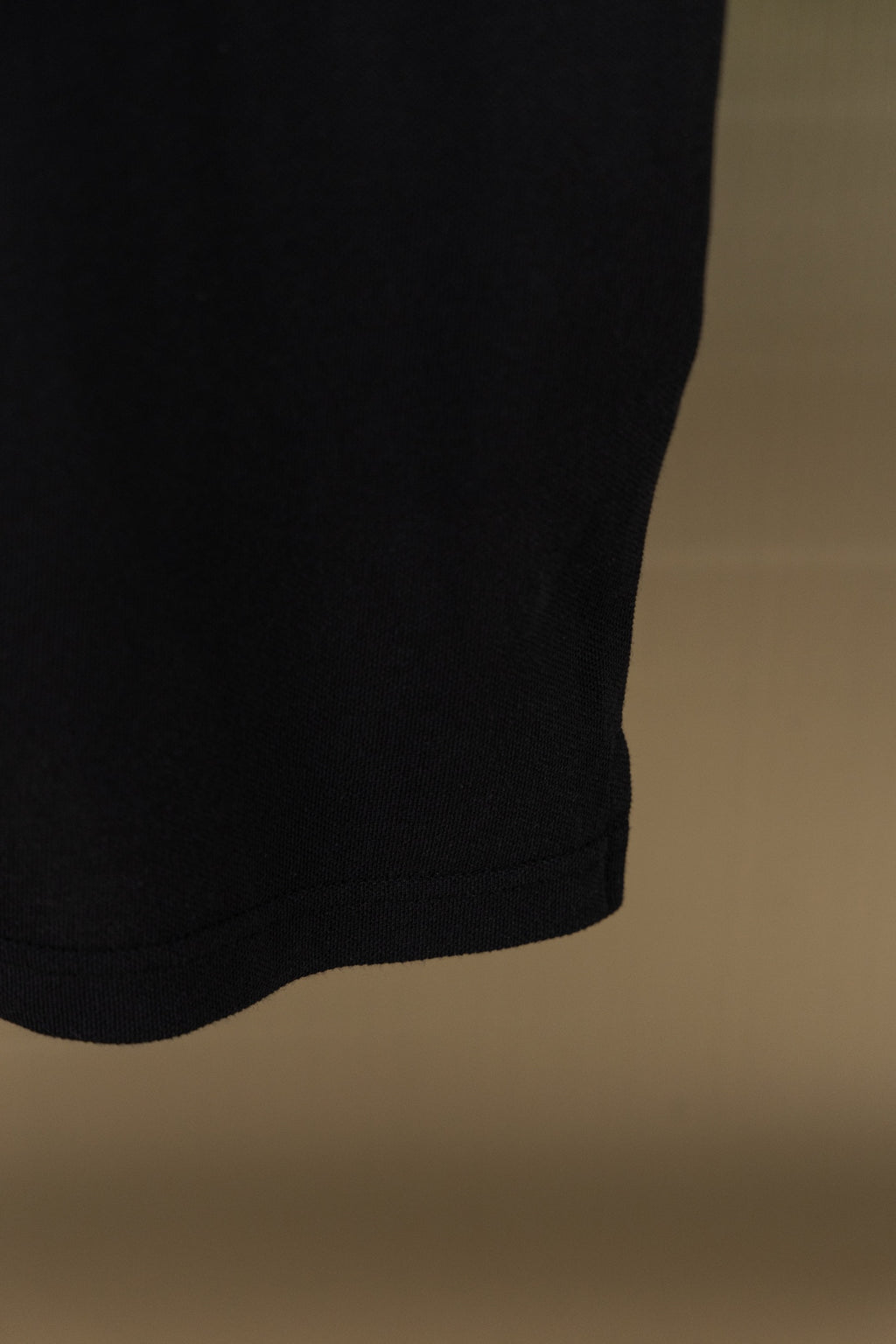 Black polo shirt side hem and fabric fold