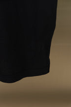 Black polo shirt side hem and fabric fold
