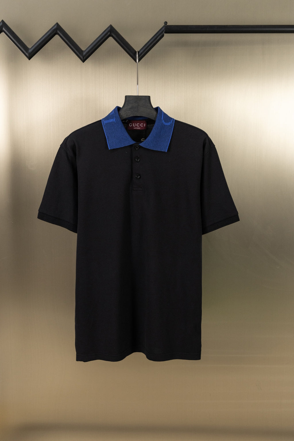 Black Gucci polo shirt with blue contrast collar and button placket