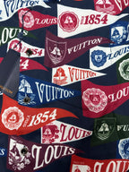 Short-sleeve shirt fabric close-up with multicolor Louis Vuitton logo, crest, and number motifs
