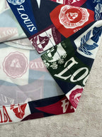 Close-up of multicolor shorts fabric with logos, seals, and 1854 emblems