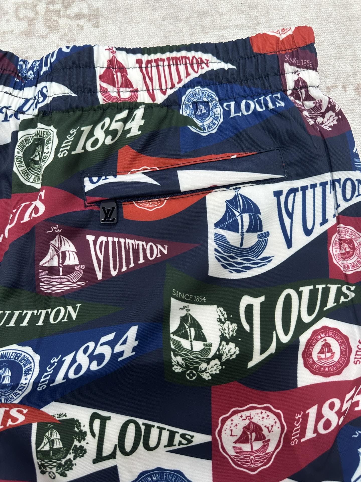 Multicolor logo shorts with elastic waistband, nautical sail and crest graphics