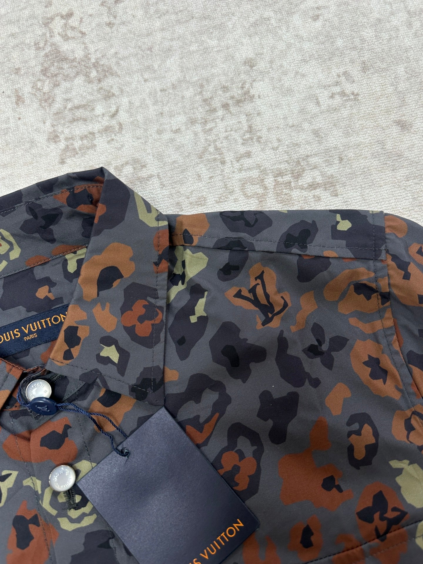 Louis Vuitton short-sleeve shirt front close-up with multicolor graphic print and tag
